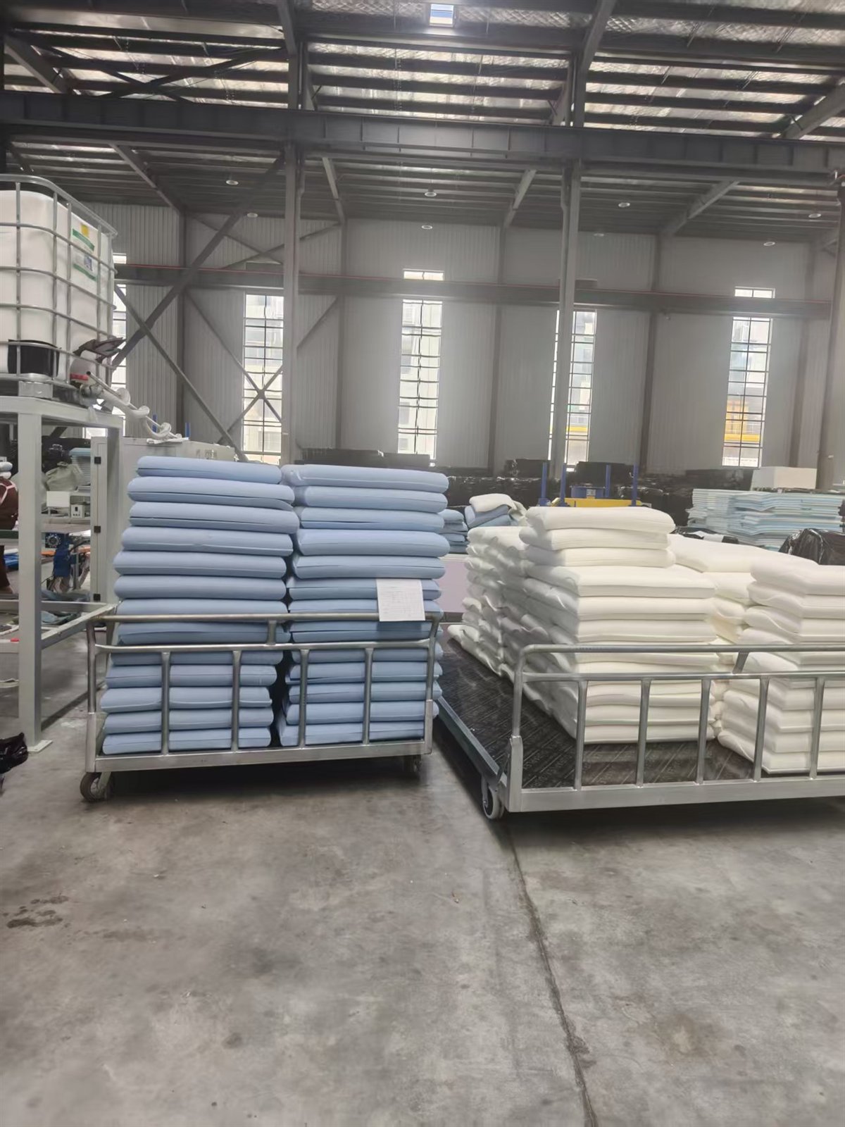 Finished memory foam pillows on production carts in Nantong factory